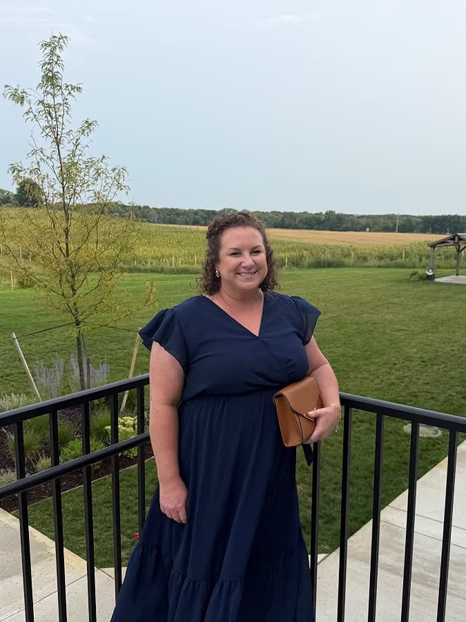 Erin on a deck overlooking the fields