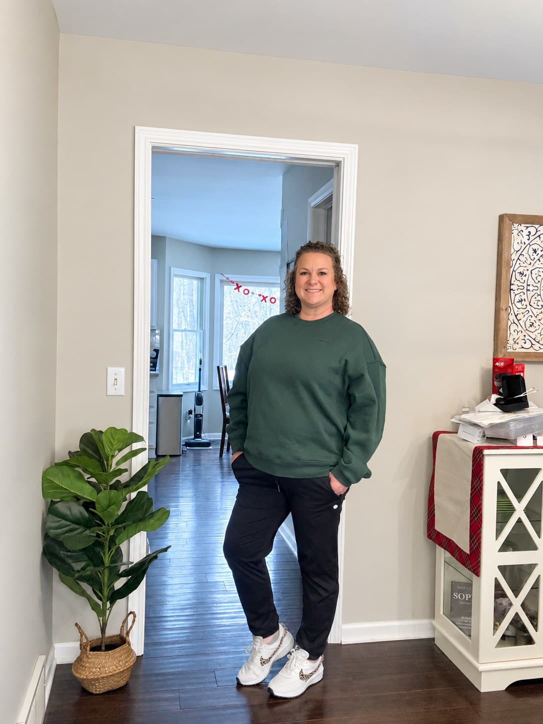 Erin at home in a green sweatshirt